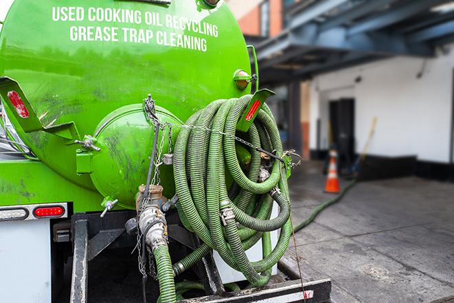 a technician pumping a grease trap in a commercial building in Peotone IL